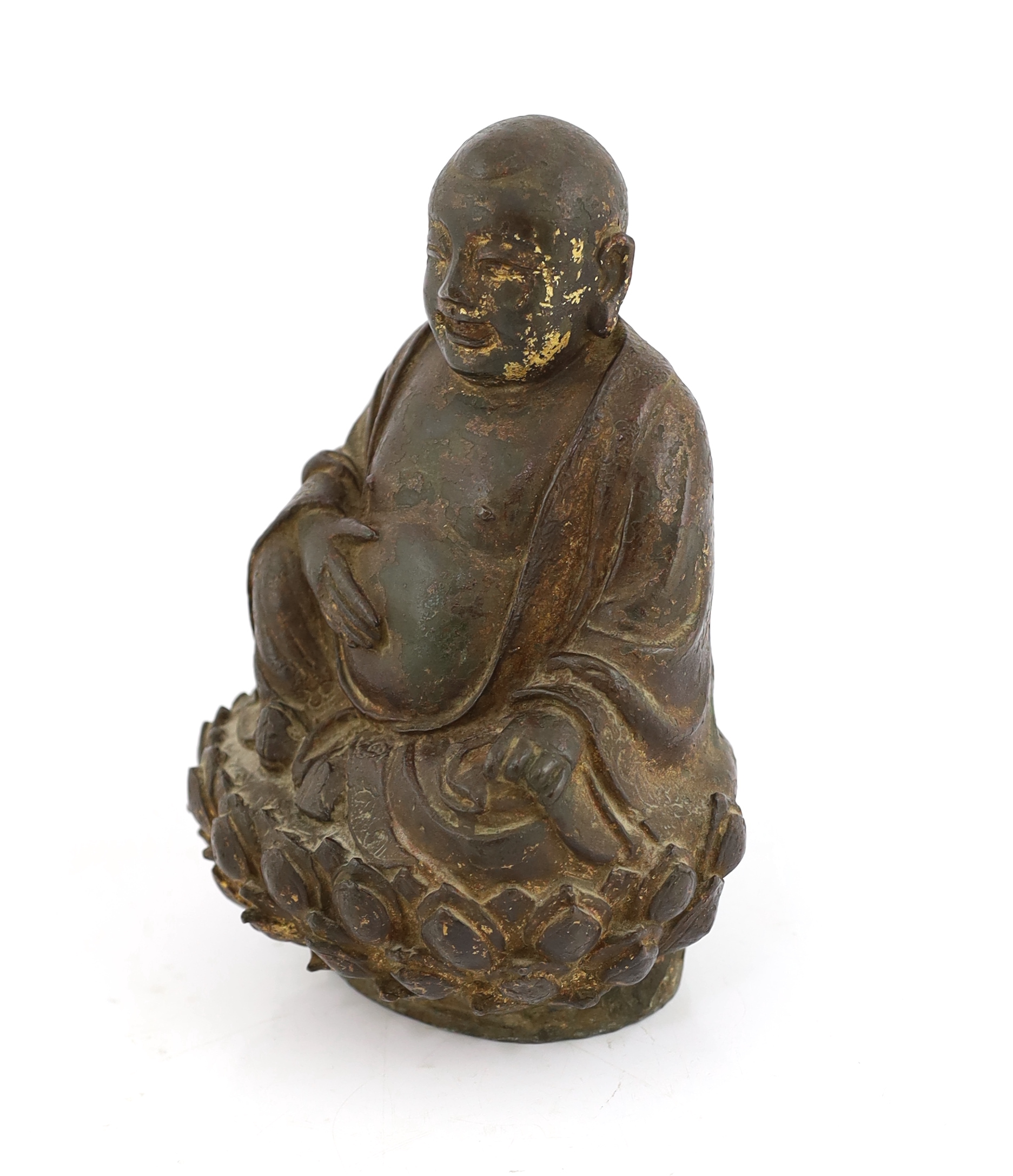 A Chinese lacquered bronze figure of Budai, late Ming dynasty, cracks and old repairs